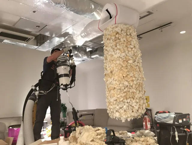Scituate Air Duct Cleaning technician performing precision vacuum insulation removal in a residential property in Scituate
